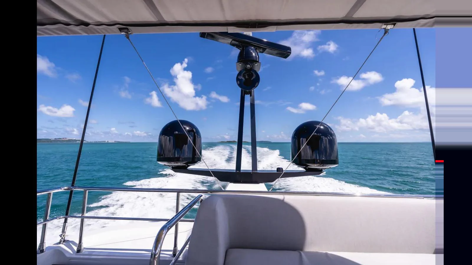 The yacht is cruising through clear blue waters, showcasing its sleek design and advanced radar equipment. aboard AZIMUT S7 Yacht for Sale
