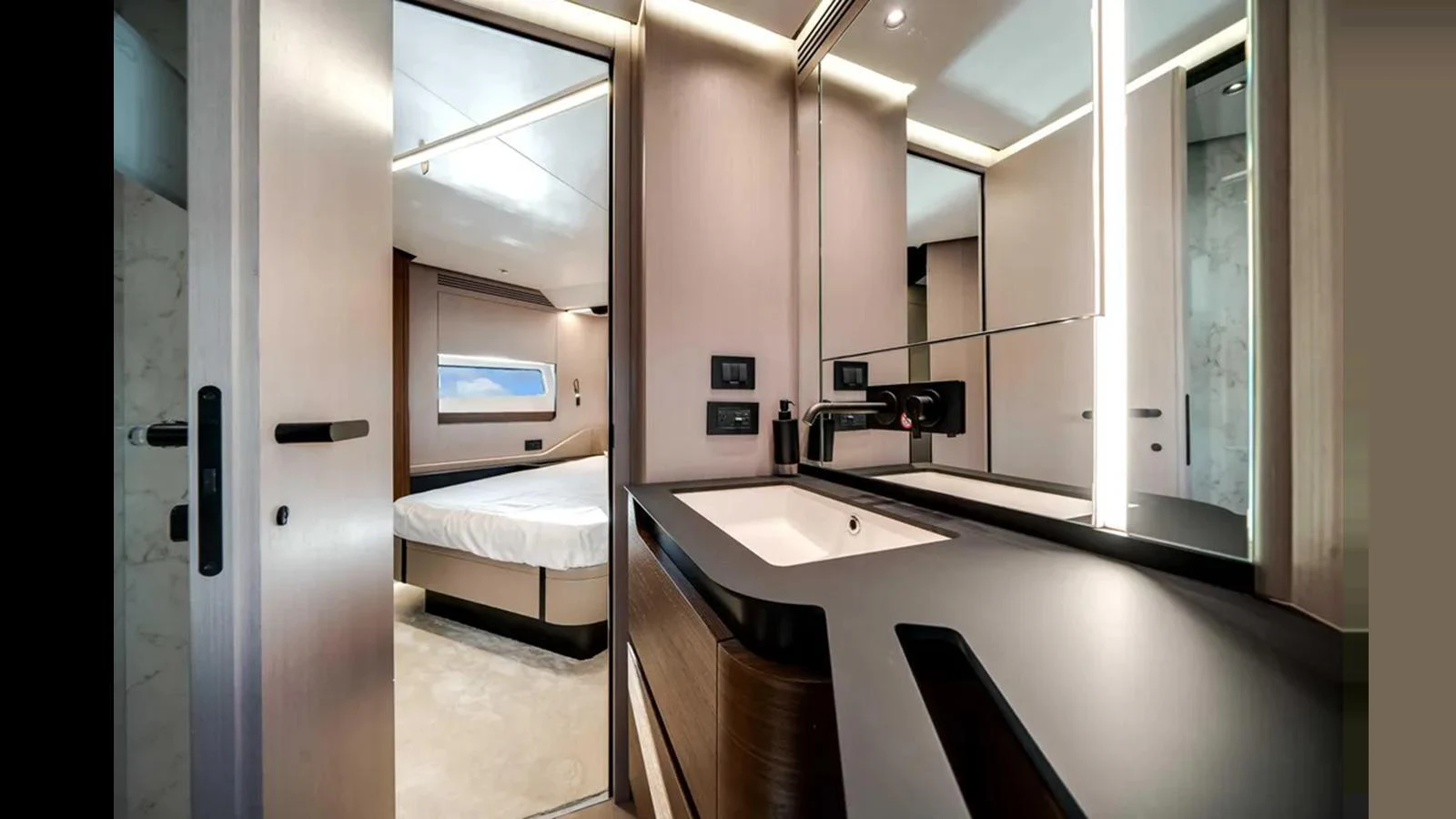 The image showcases a luxurious stateroom with an ensuite bathroom, featuring modern design and elegant finishes. aboard 2025 AZIMUT S8 Yacht for Sale