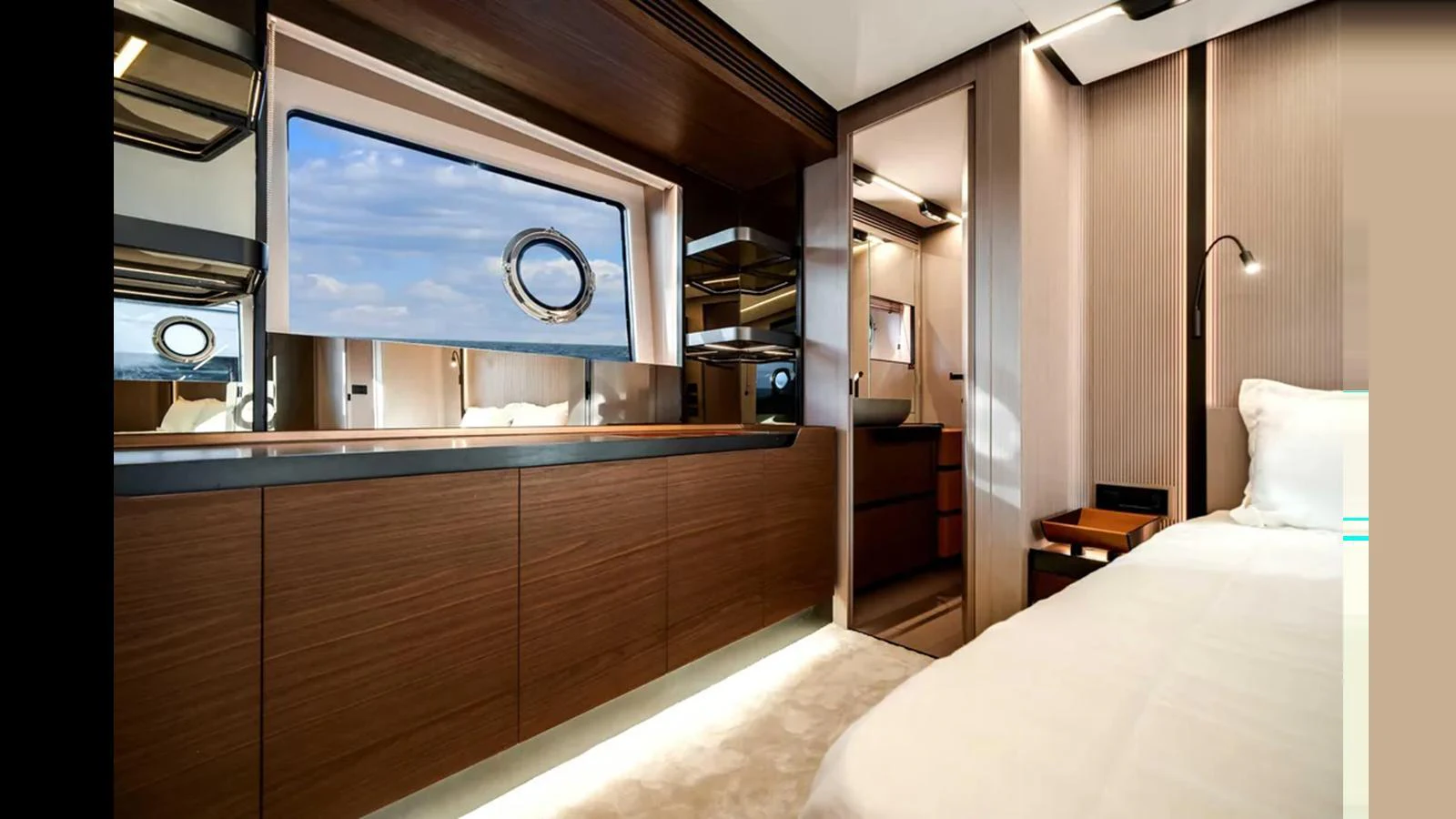 The stateroom features elegant wood finishes, a large window, and modern lighting. aboard 2025 AZIMUT S8 Yacht for Sale