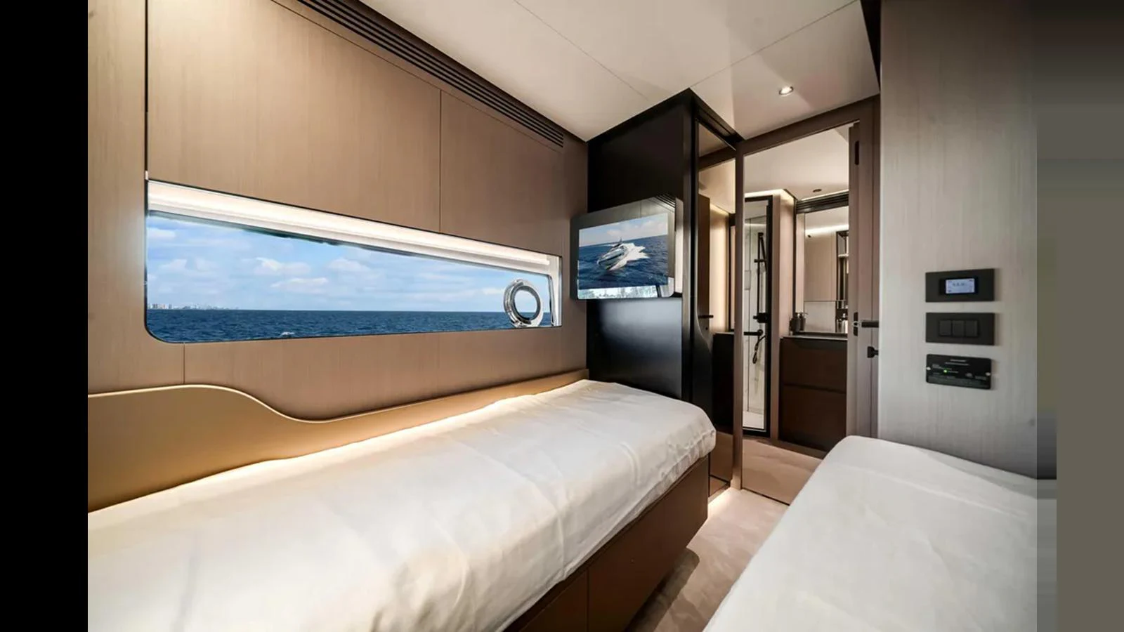 The guest cabin features twin beds, a large window with a sea view, and modern amenities. aboard 2025 AZIMUT S8 Yacht for Sale