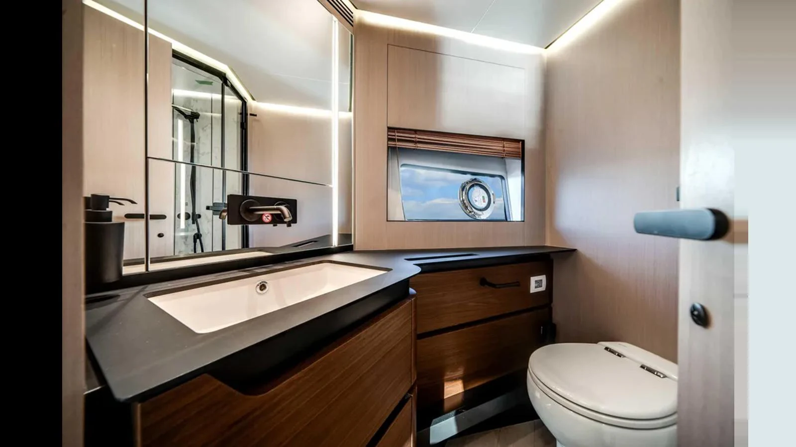 This modern yacht bathroom features sleek wood cabinetry, a stylish sink, and a large mirror, creating a luxurious and functional space. aboard 2025 AZIMUT S8 Yacht for Sale