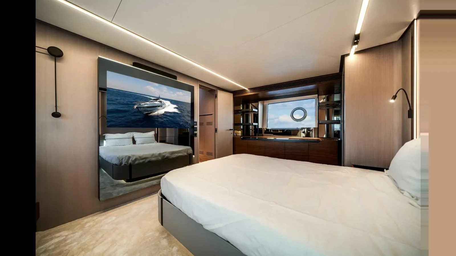 A luxurious stateroom featuring a large bed, modern decor, and a flat-screen TV displaying a yacht on the water. aboard 2025 AZIMUT S8 Yacht for Sale