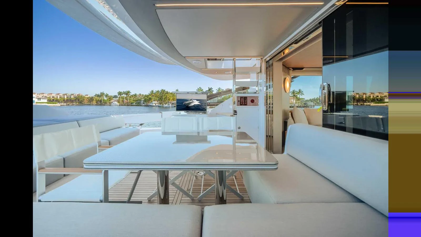 The aft deck offers a luxurious outdoor seating area with a sleek dining table and a view of the serene waters. aboard 2025 AZIMUT S8 Yacht for Sale