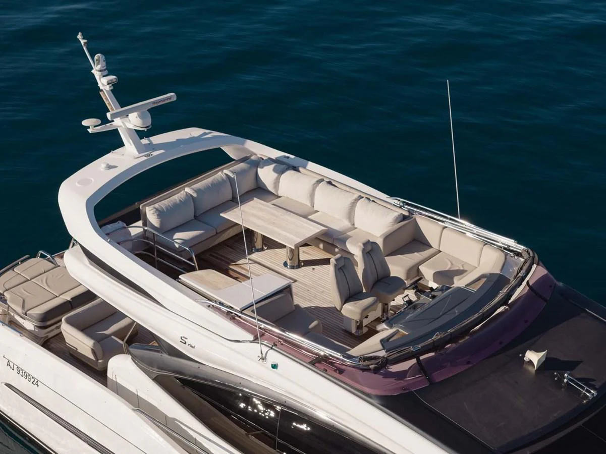 The yacht's flybridge offers a spacious and luxurious seating area with a dining table, perfect for outdoor relaxation and entertainment. aboard CAMILLE Yacht for Sale