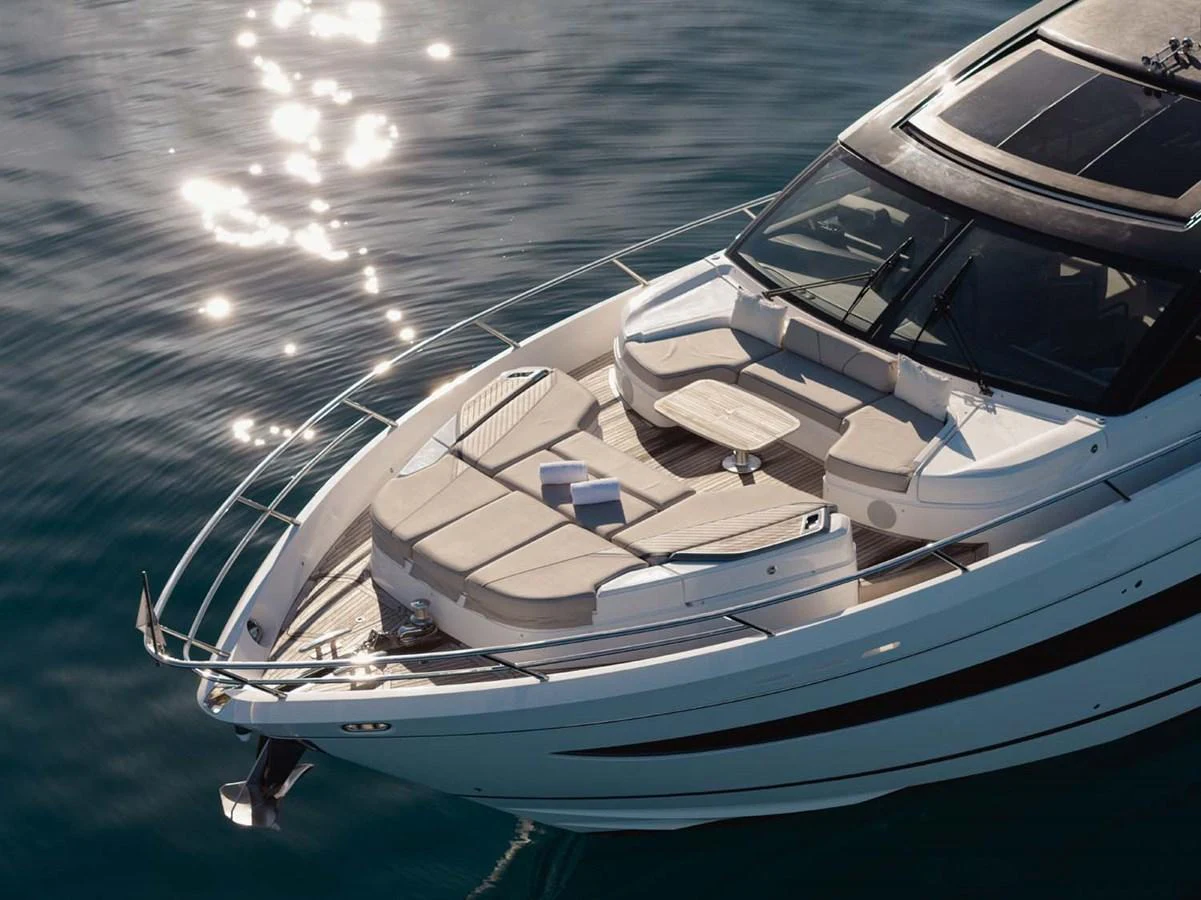 The yacht's bow features a luxurious sunbathing area with plush seating and a small table, perfect for relaxation. aboard CAMILLE Yacht for Sale