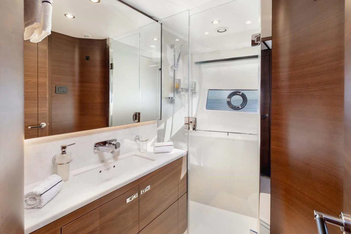 The yacht's bathroom features modern fixtures and a sleek design with ample lighting. aboard CAMILLE Yacht for Sale