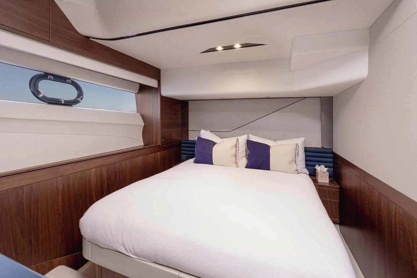 A cozy and well-appointed stateroom with a large bed and modern decor. aboard CAMILLE Yacht for Sale