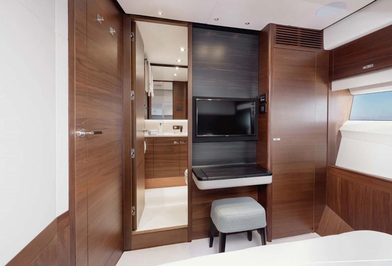 The yacht's interior features a modern and elegant design with wooden finishes and a cozy seating area. aboard CAMILLE Yacht for Sale