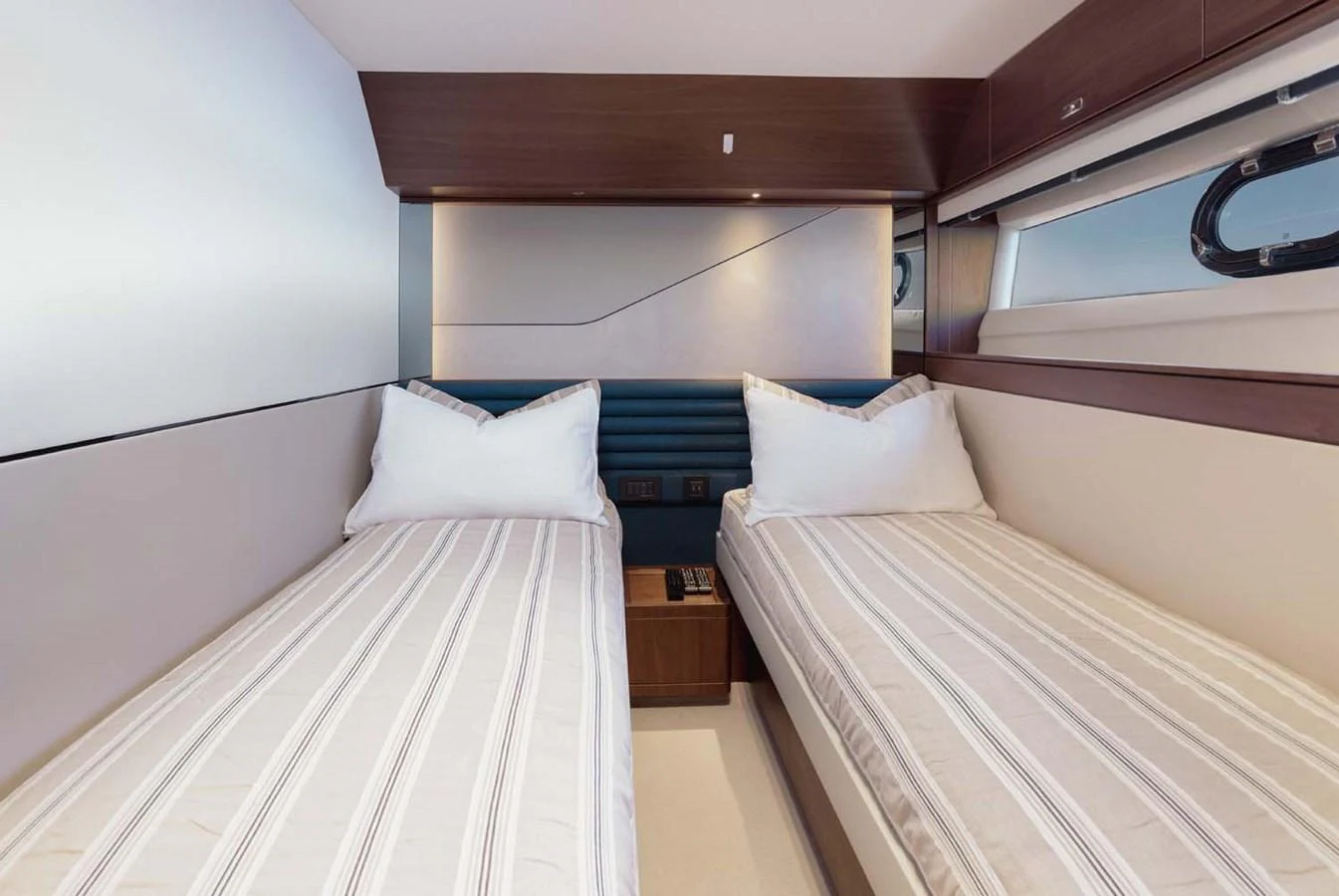 The twin stateroom offers a cozy and modern sleeping arrangement with two single beds and elegant decor. aboard CAMILLE Yacht for Sale