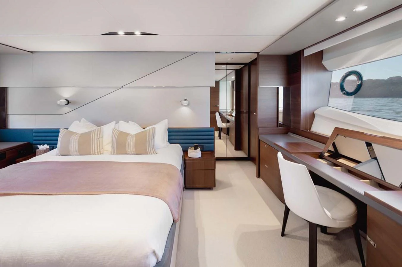 The master stateroom features a luxurious bed, a vanity desk, and large windows offering serene views. aboard CAMILLE Yacht for Sale