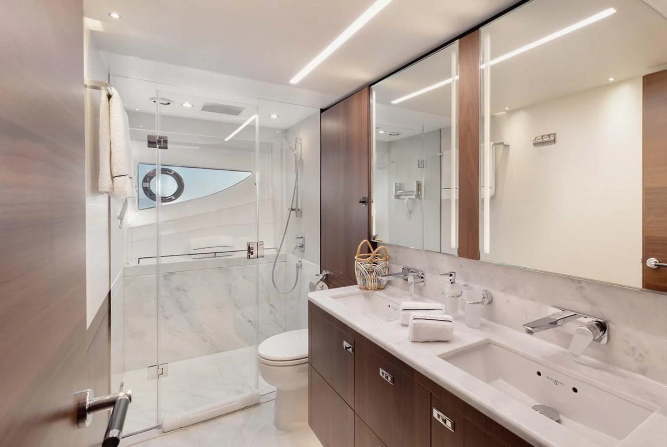 A luxurious yacht bathroom featuring a spacious shower and elegant fixtures. aboard CAMILLE Yacht for Sale