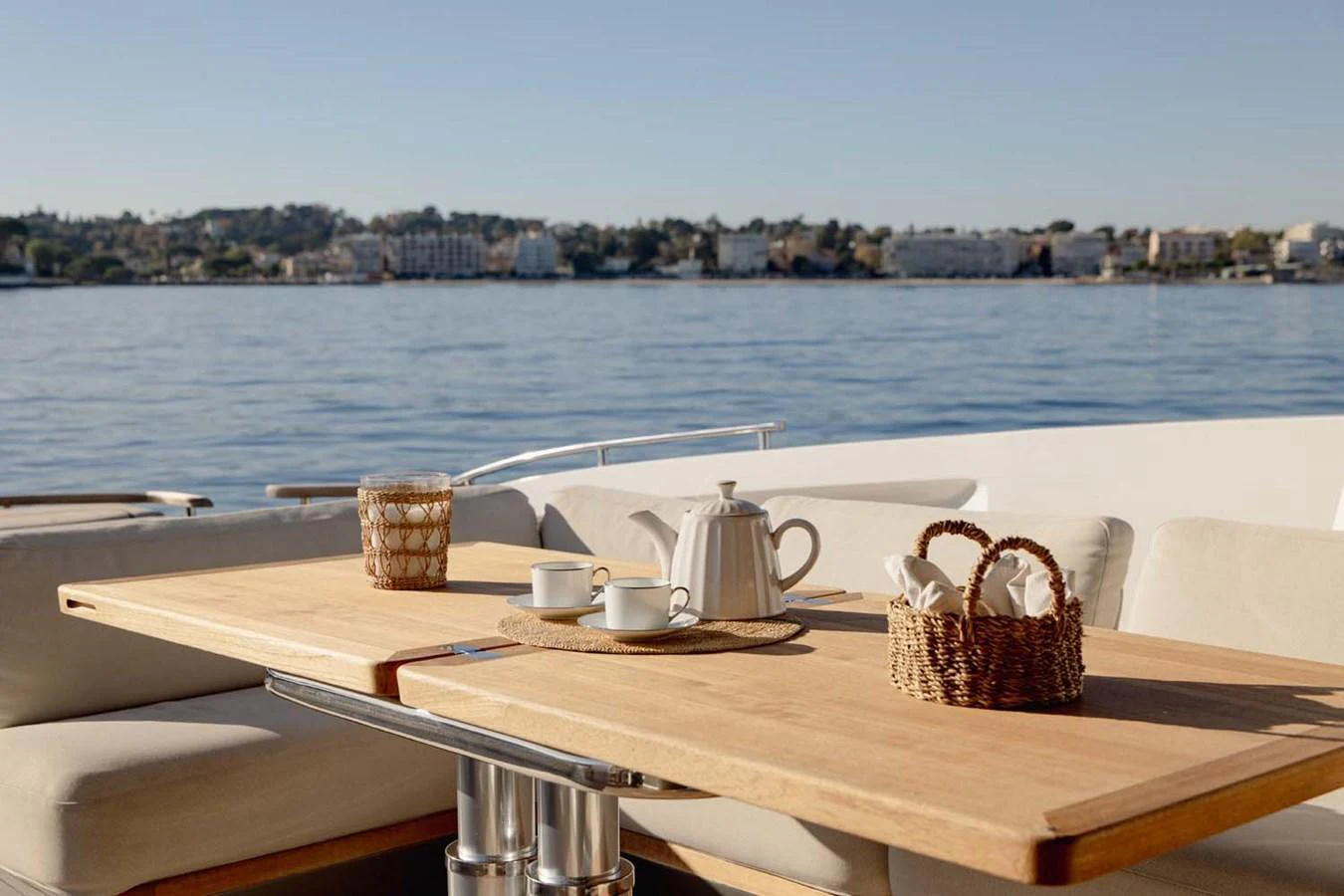 The aft deck features a cozy dining area with a wooden table and comfortable seating, perfect for enjoying meals with a view. aboard CAMILLE Yacht for Sale