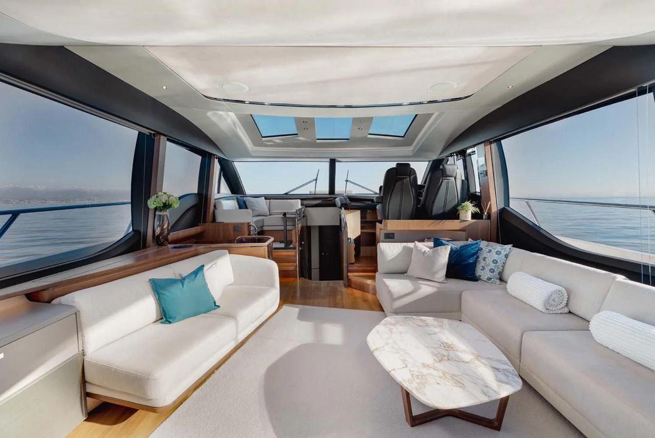 The yacht's salon features luxurious seating with panoramic views and modern decor. aboard CAMILLE Yacht for Sale