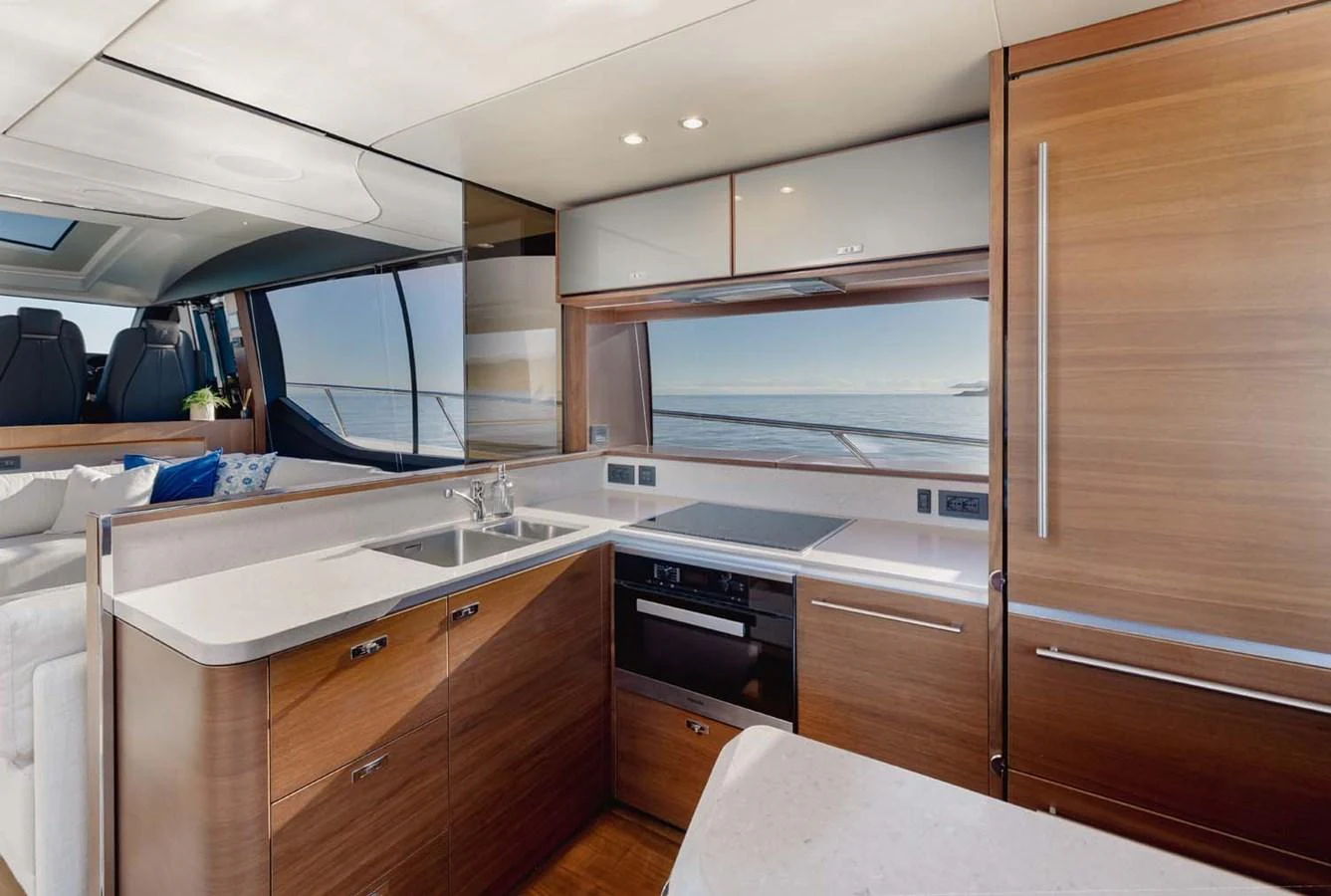 The yacht's galley features modern appliances and sleek wooden cabinetry, offering a stylish and functional space for meal preparation. aboard CAMILLE Yacht for Sale