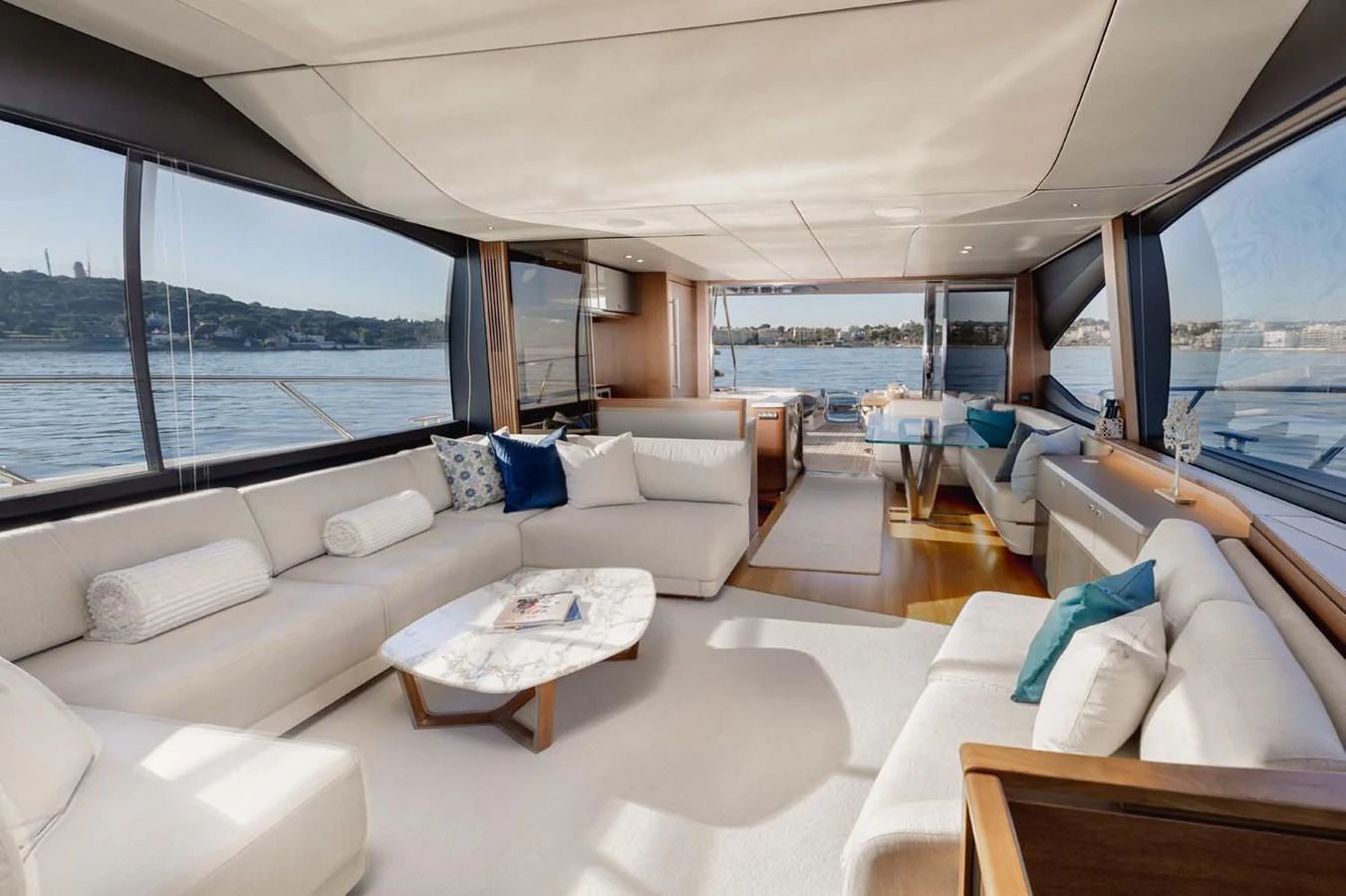 The yacht's salon features luxurious seating with panoramic views of the water. aboard CAMILLE Yacht for Sale