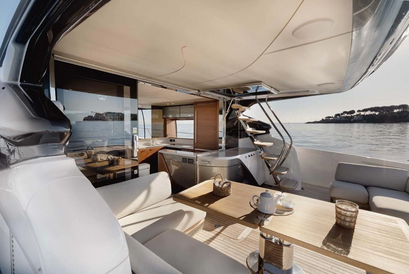 The aft deck offers a luxurious and inviting space with comfortable seating and a dining area, perfect for enjoying meals with a view of the sea. aboard CAMILLE Yacht for Sale