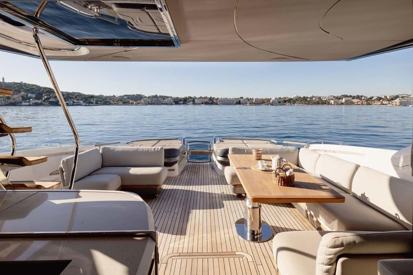 The aft deck features a spacious seating area with a large dining table, perfect for alfresco dining and relaxation. aboard CAMILLE Yacht for Sale