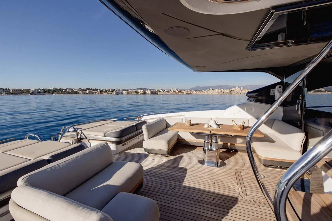 The aft deck offers a luxurious outdoor seating and dining area with stunning views of the water. aboard CAMILLE Yacht for Sale