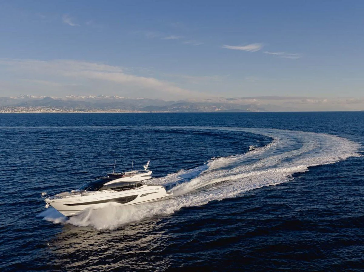 A sleek yacht cruises swiftly across the open sea, leaving a graceful wake behind. aboard CAMILLE Yacht for Sale