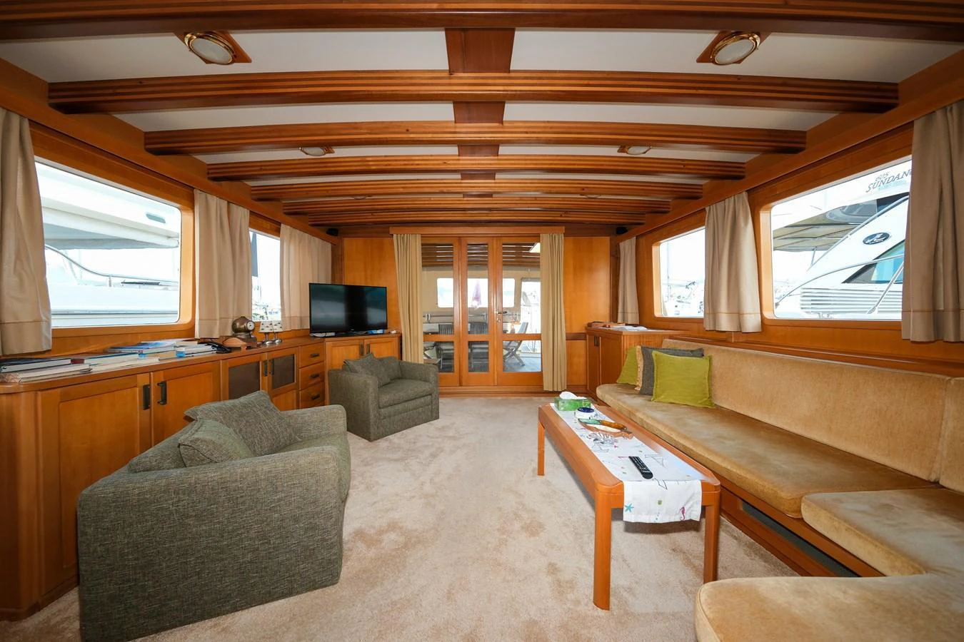 The salon features comfortable seating and large windows, creating a bright and inviting space. aboard XANAX Yacht for Sale