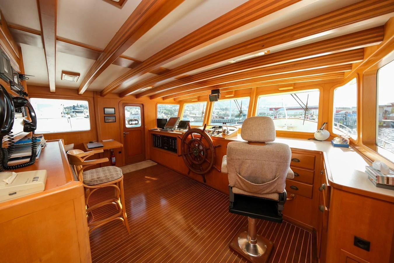 The helm station features a spacious and well-lit area with ample seating and advanced navigation equipment. aboard XANAX Yacht for Sale