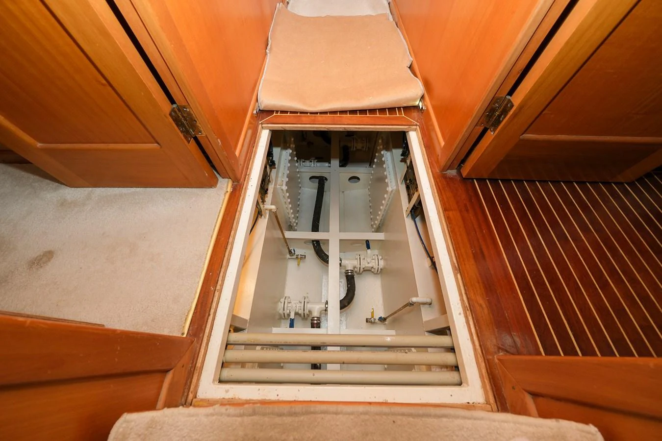 This image showcases the yacht's mechanical access area with visible piping and structural components. aboard XANAX Yacht for Sale