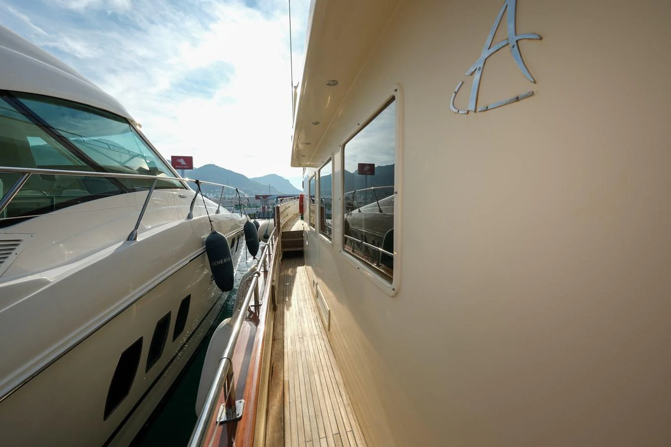 The side deck of the yacht offers a sleek passage with a view of the water and nearby vessels. aboard XANAX Yacht for Sale
