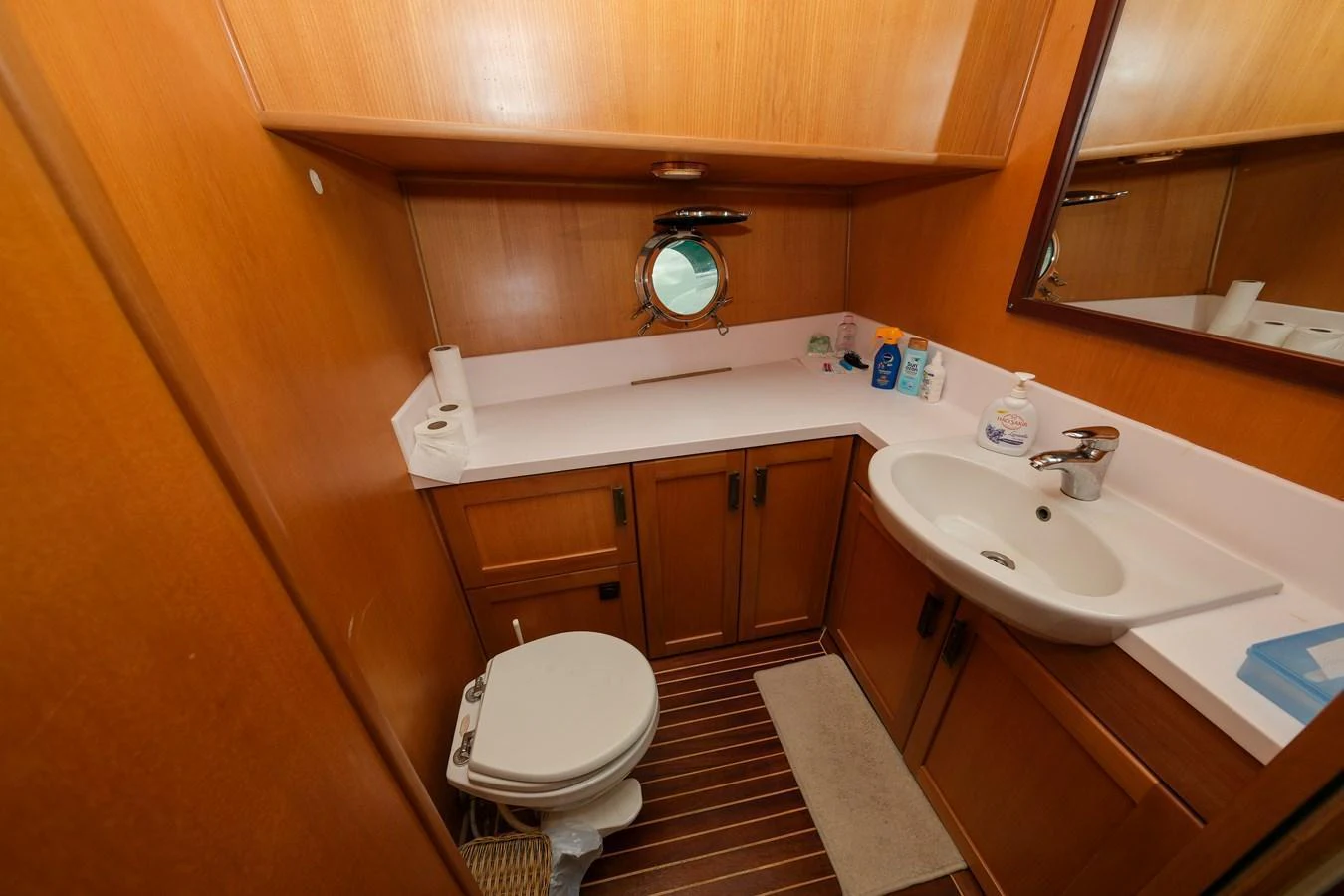 The yacht's head features a compact and functional design with wooden cabinetry and modern fixtures. aboard XANAX Yacht for Sale