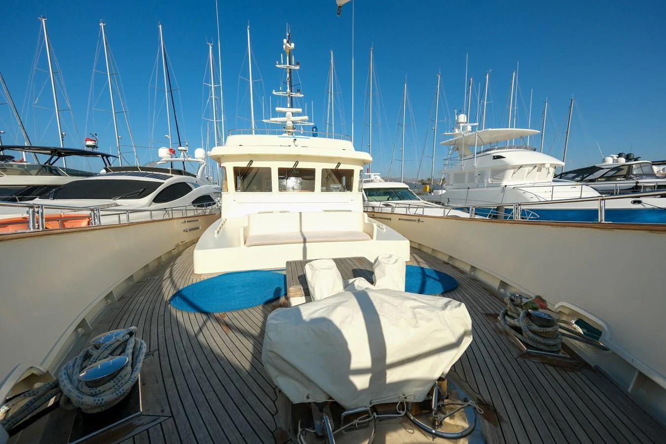 The yacht's foredeck features a spacious seating area with a clear view of the marina. aboard XANAX Yacht for Sale
