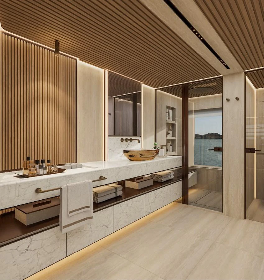 The yacht's bathroom features elegant wood paneling, a marble countertop, and a scenic window view. aboard GRANTURISMO 66M Yacht for Sale