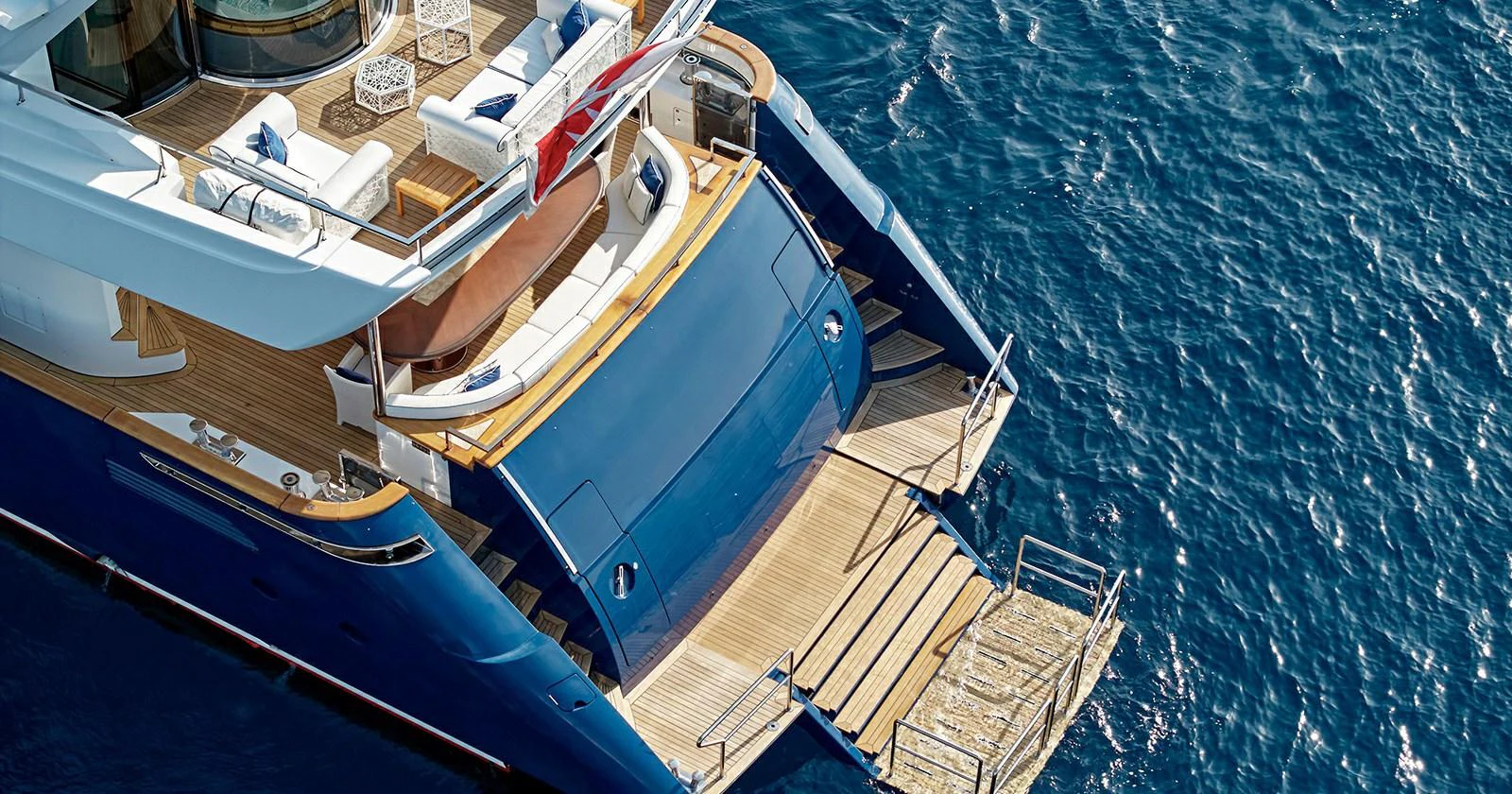 The yacht's aft deck features a spacious lounging area with direct access to the water. aboard COF Yacht for Sale
