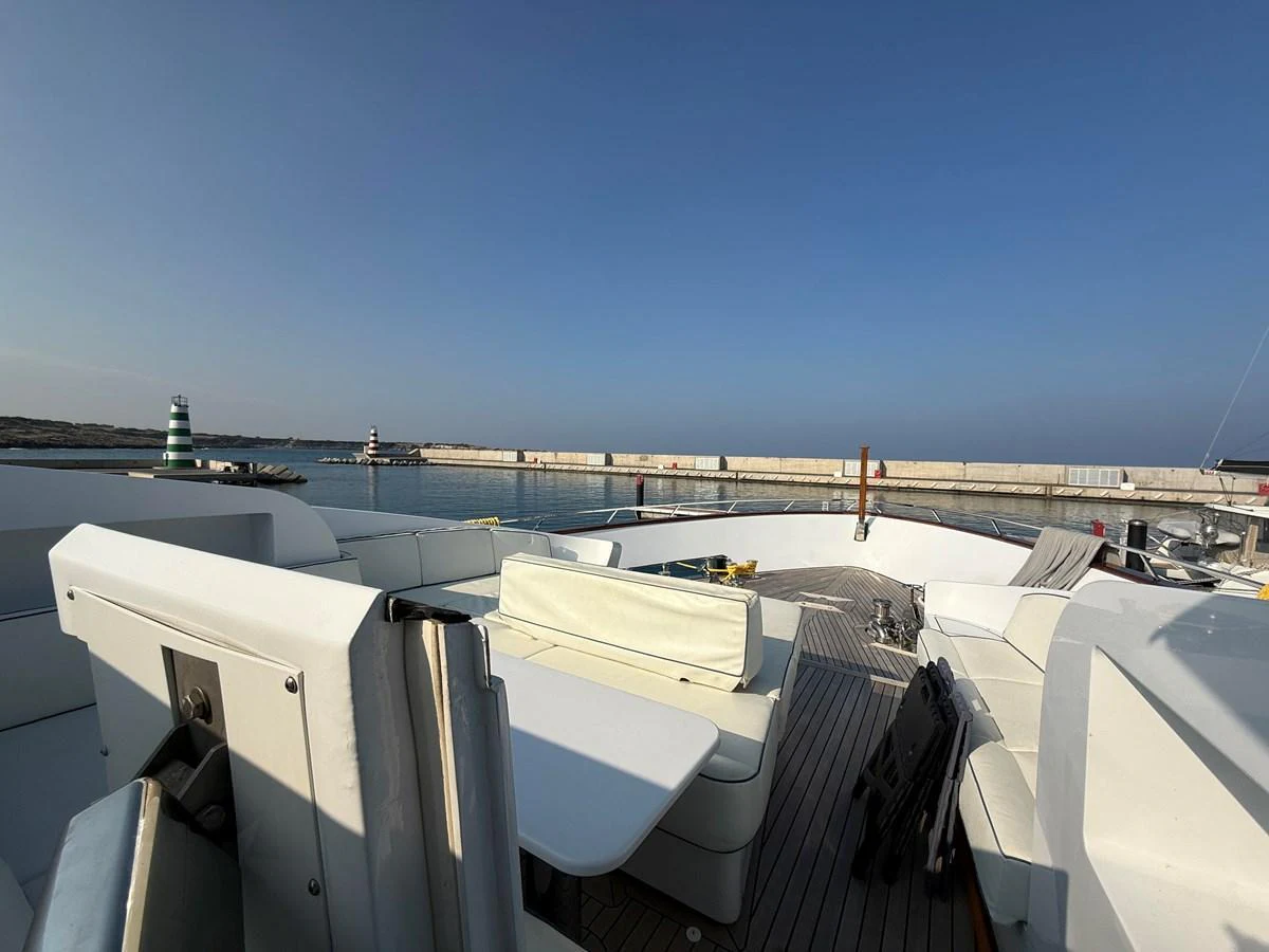 The flybridge offers spacious seating with a serene view of the harbor. aboard COF Yacht for Sale