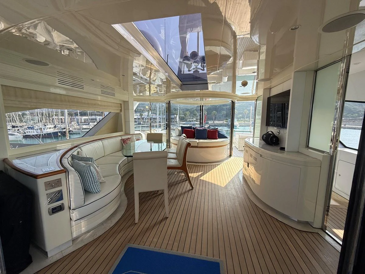 The yacht's salon features elegant seating with panoramic views and ample natural light. aboard COF Yacht for Sale