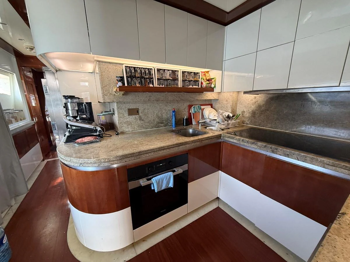 The yacht's galley features modern appliances and ample counter space for meal preparation. aboard COF Yacht for Sale