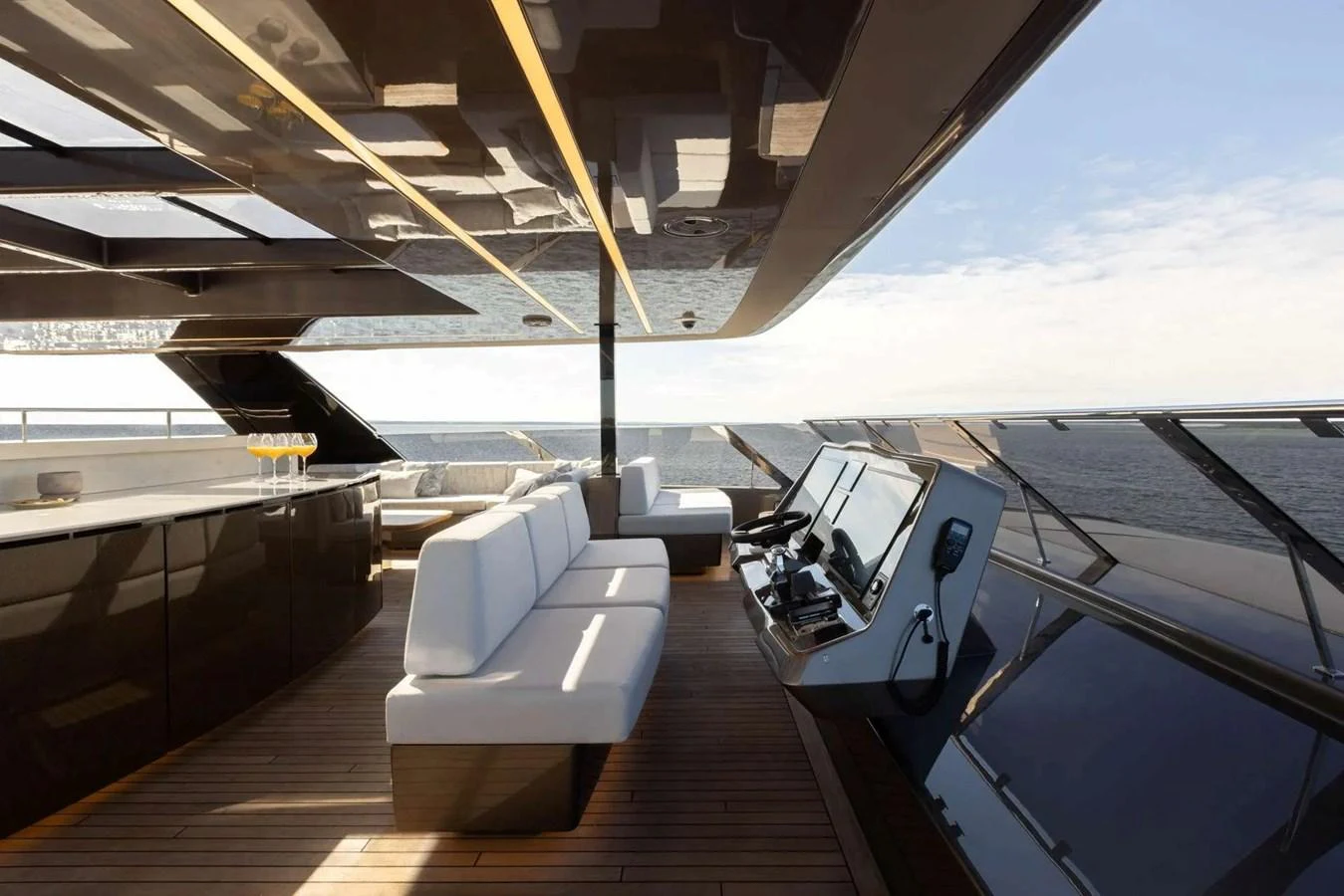 The sleek helm area features modern controls and comfortable seating with a panoramic view of the sea. aboard TWILIGHT Yacht for Sale