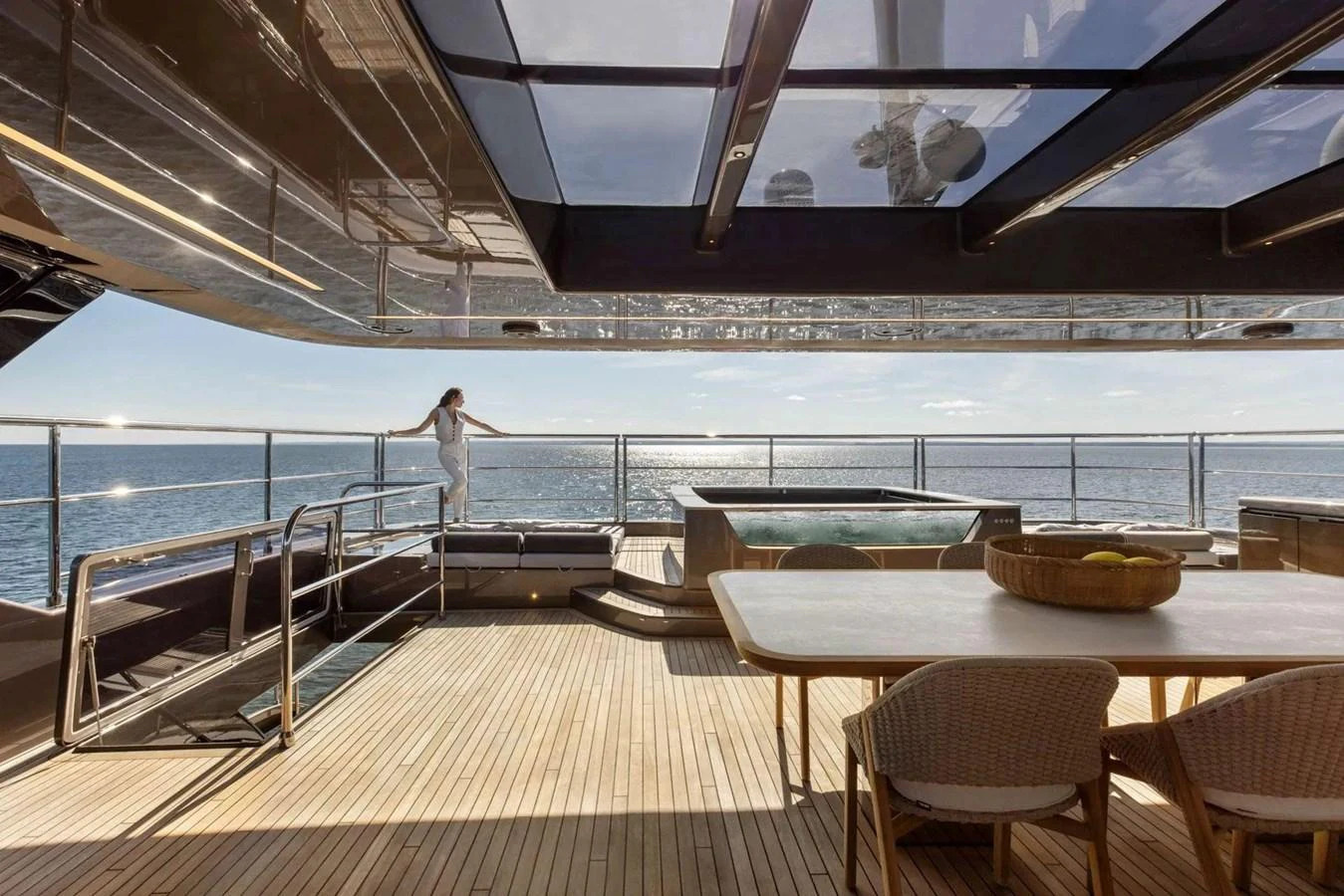 The aft deck features a luxurious seating area with a dining table and a jacuzzi, offering stunning ocean views. aboard TWILIGHT Yacht for Sale
