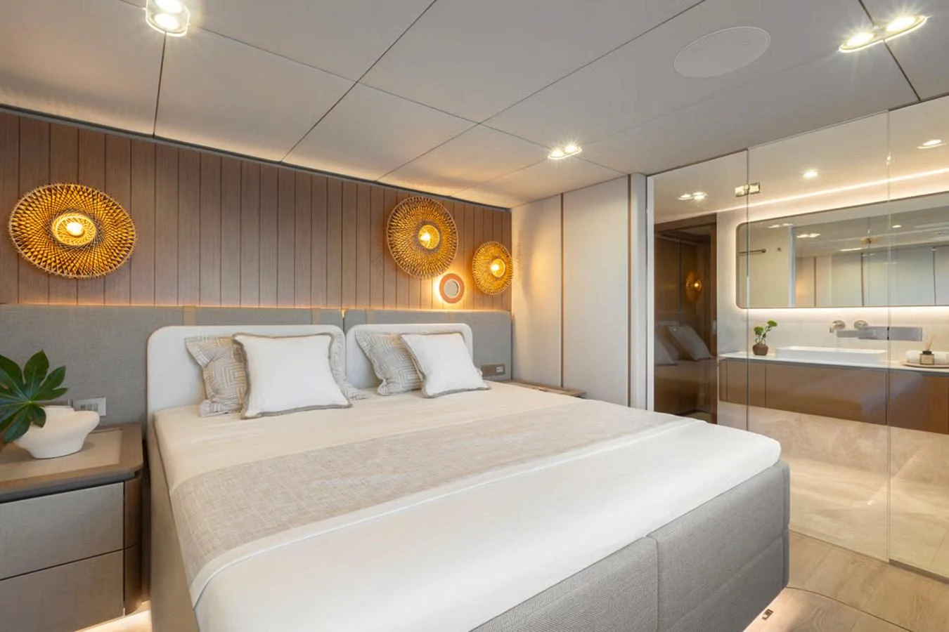The stateroom features a luxurious bed with elegant lighting and modern decor. aboard TWILIGHT Yacht for Sale