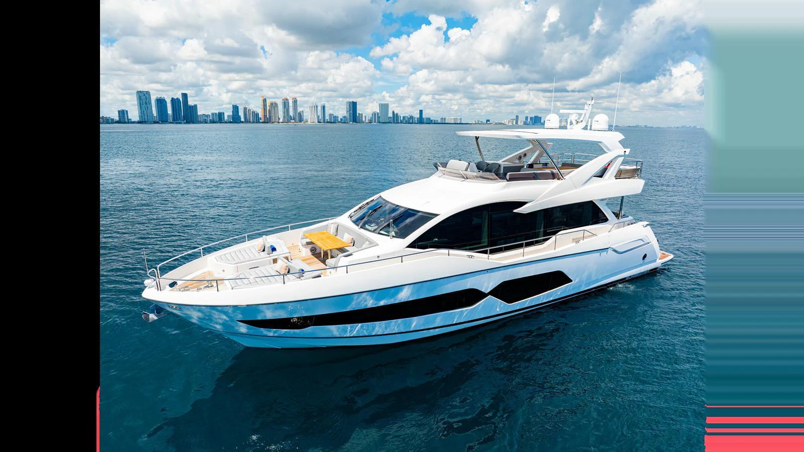 A sleek and modern yacht cruising on calm waters with a city skyline in the background. aboard STEELN Yacht for Sale