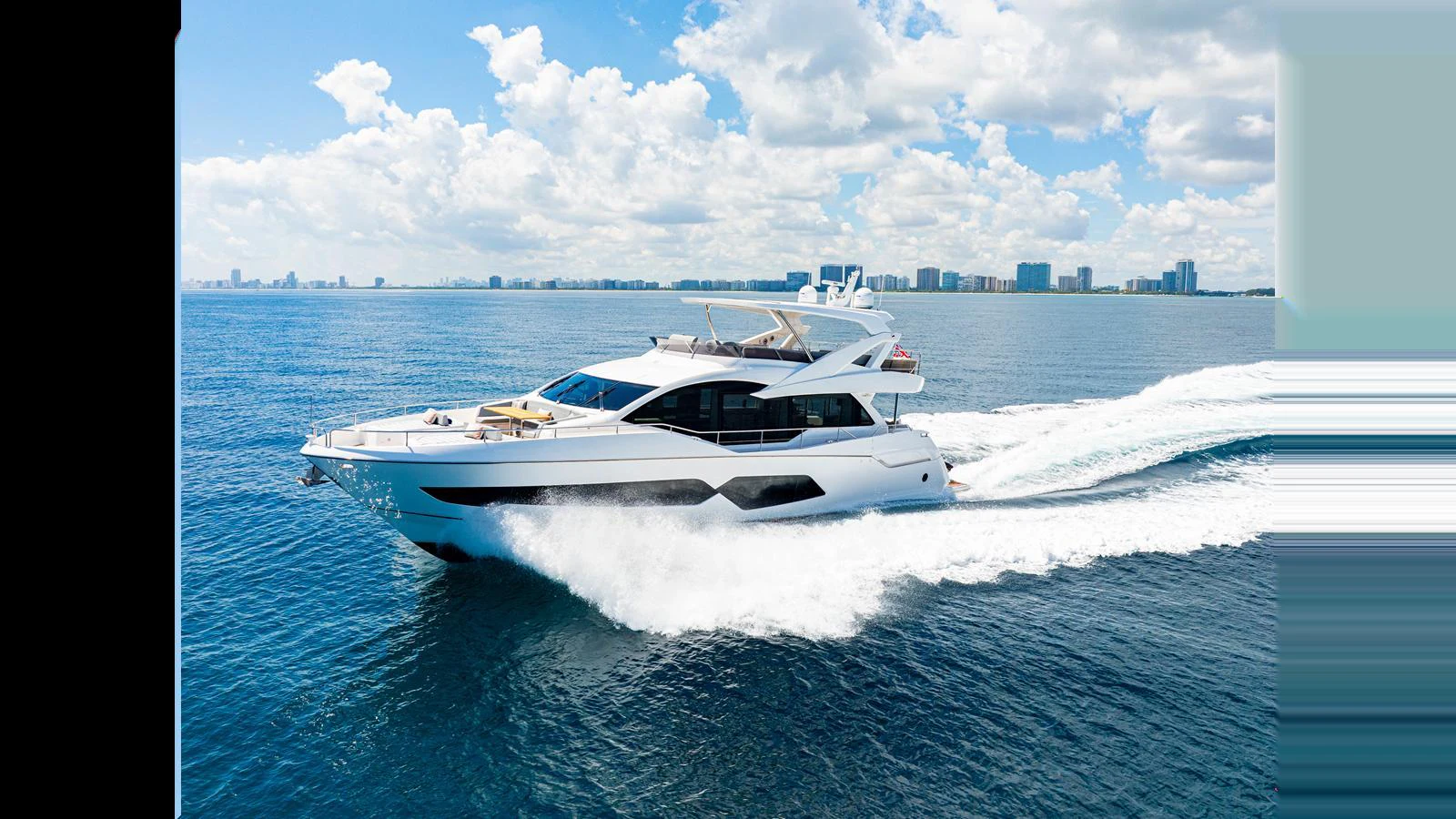 A sleek yacht cruises through the water on a sunny day, showcasing its modern design and spacious decks. aboard STEELN Yacht for Sale