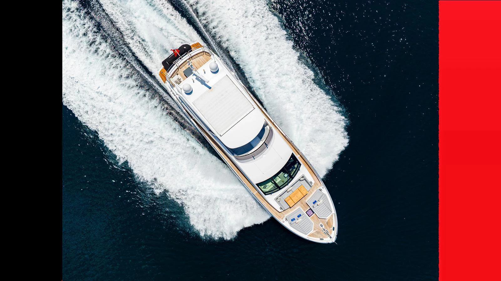 A sleek yacht cruises through the water, leaving a trail of white wake behind. aboard STEELN Yacht for Sale