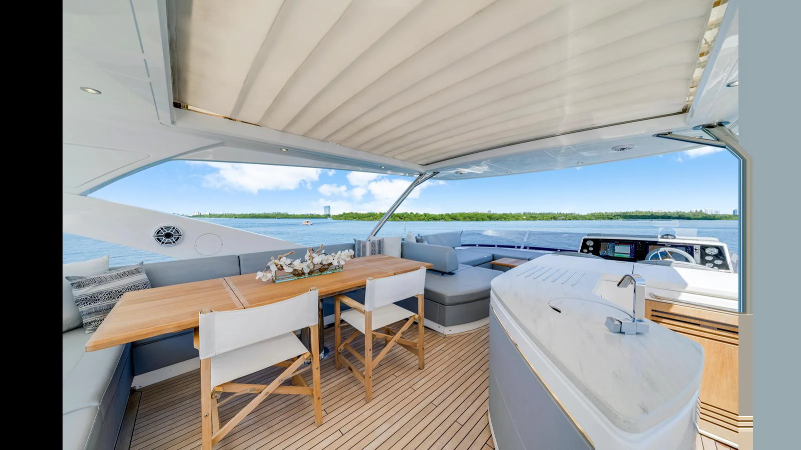 The flybridge offers a spacious and elegant outdoor dining and lounging area with a stunning view. aboard STEELN Yacht for Sale