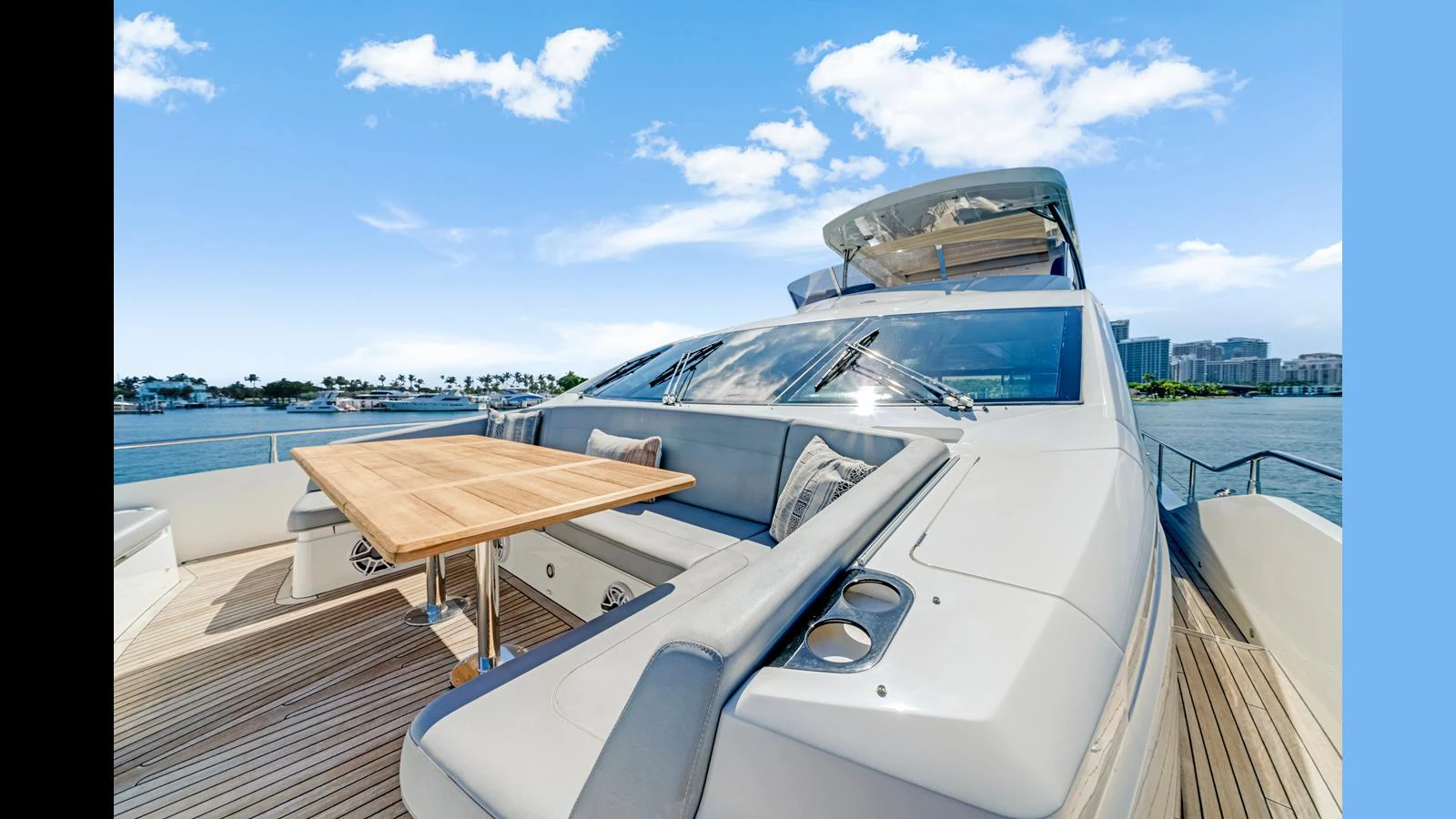 The yacht's aft deck features a spacious seating area with a wooden table, perfect for outdoor dining and relaxation. aboard STEELN Yacht for Sale