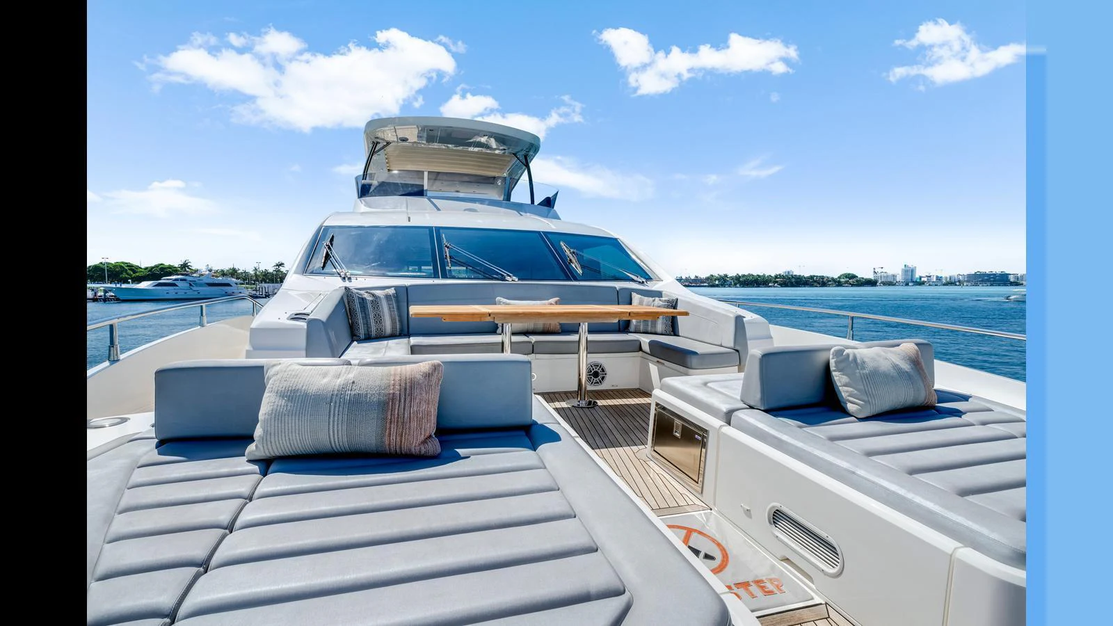 The foredeck features luxurious sun pads and a stylish seating area with a table, perfect for relaxation and socializing. aboard STEELN Yacht for Sale