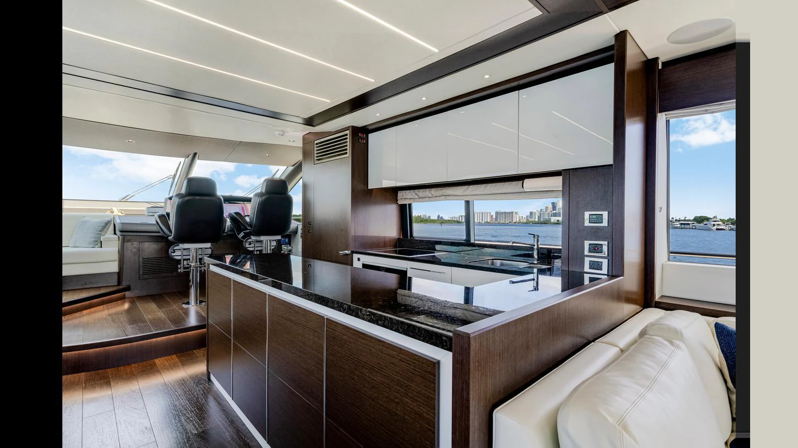The modern galley features sleek cabinetry, a spacious countertop, and panoramic windows offering stunning views. aboard STEELN Yacht for Sale