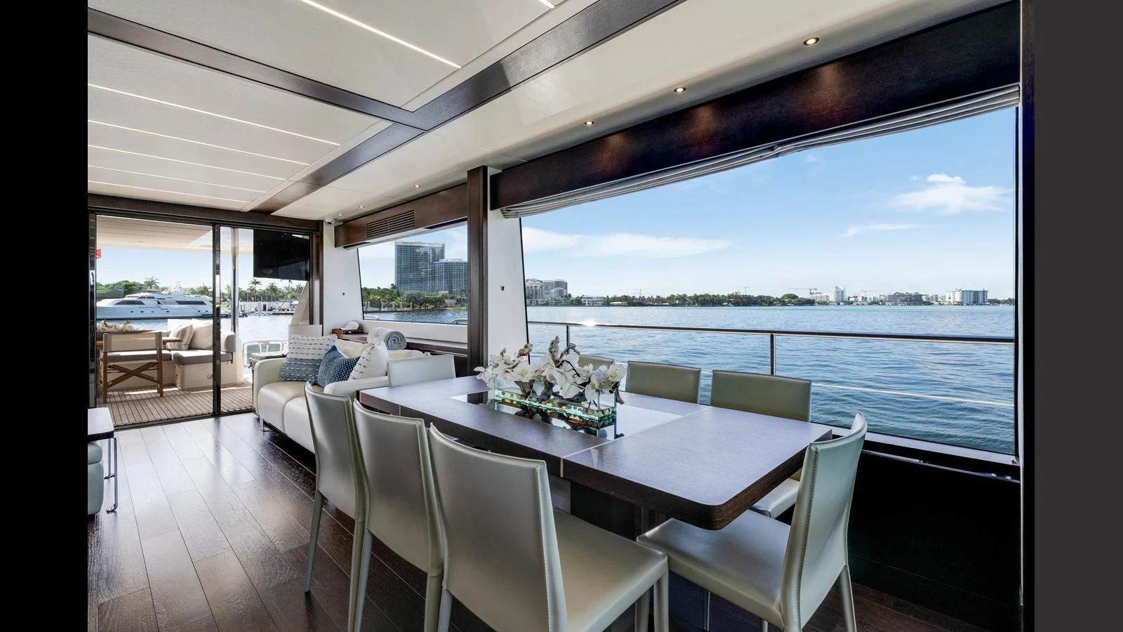 The yacht's dining area offers a luxurious setting with panoramic views of the water. aboard STEELN Yacht for Sale