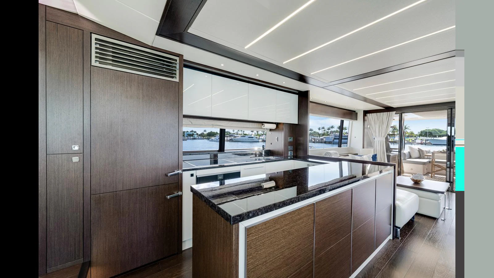 The modern galley features sleek cabinetry and a spacious layout with a view of the water. aboard STEELN Yacht for Sale