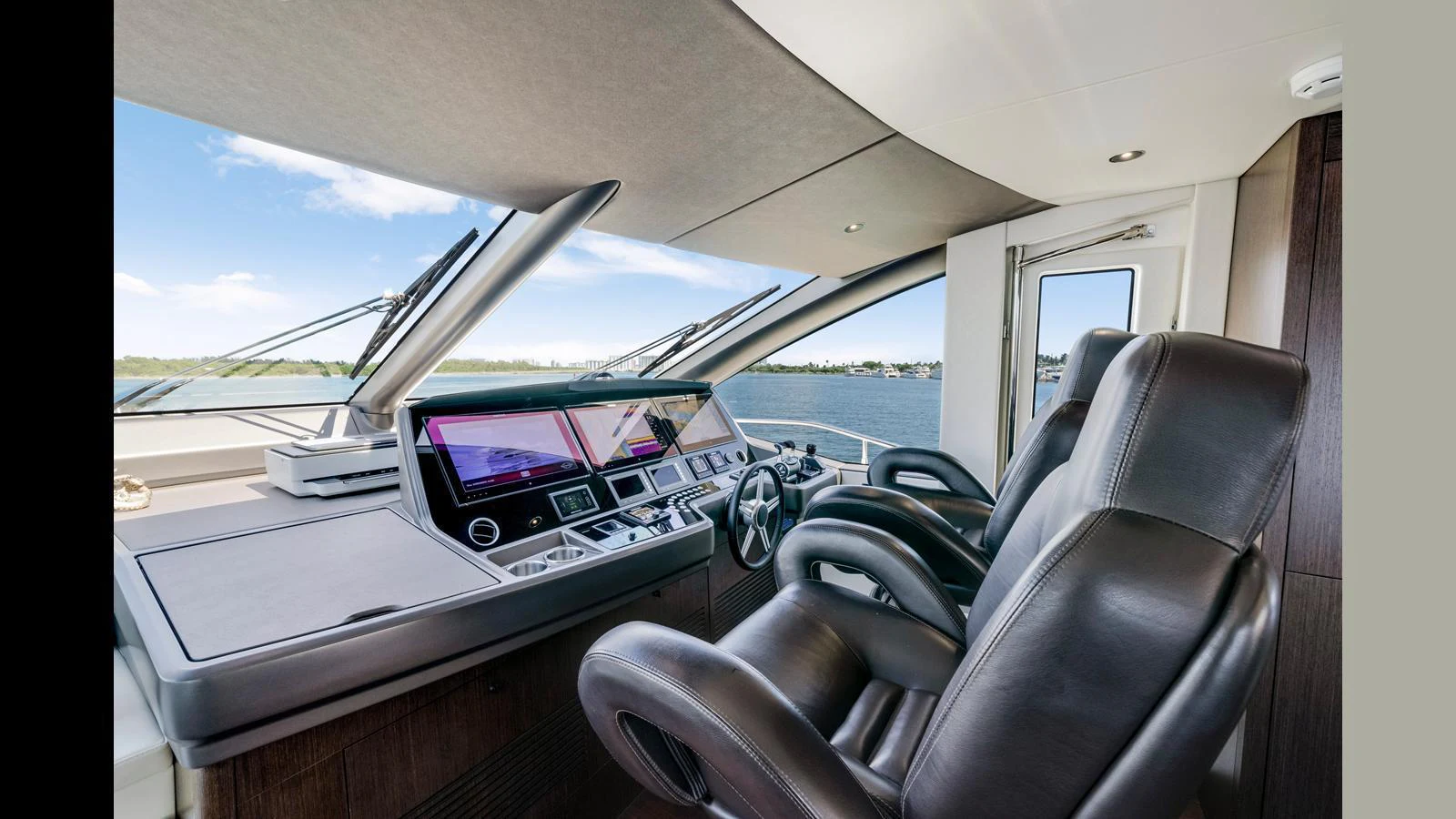 The helm station features luxurious leather seating and state-of-the-art navigation equipment with a panoramic view. aboard STEELN Yacht for Sale