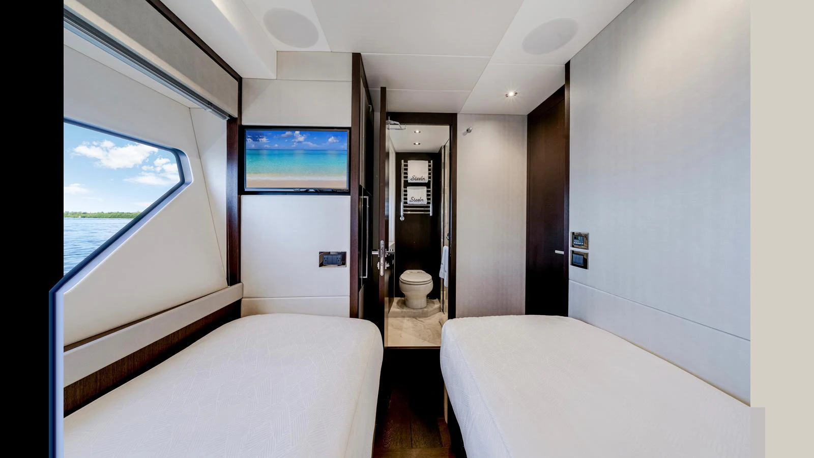 The guest stateroom features twin beds and a view of the sea through a large window. aboard STEELN Yacht for Sale
