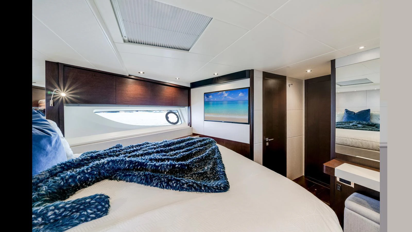 A luxurious stateroom featuring a large bed with plush bedding and modern decor. aboard STEELN Yacht for Sale