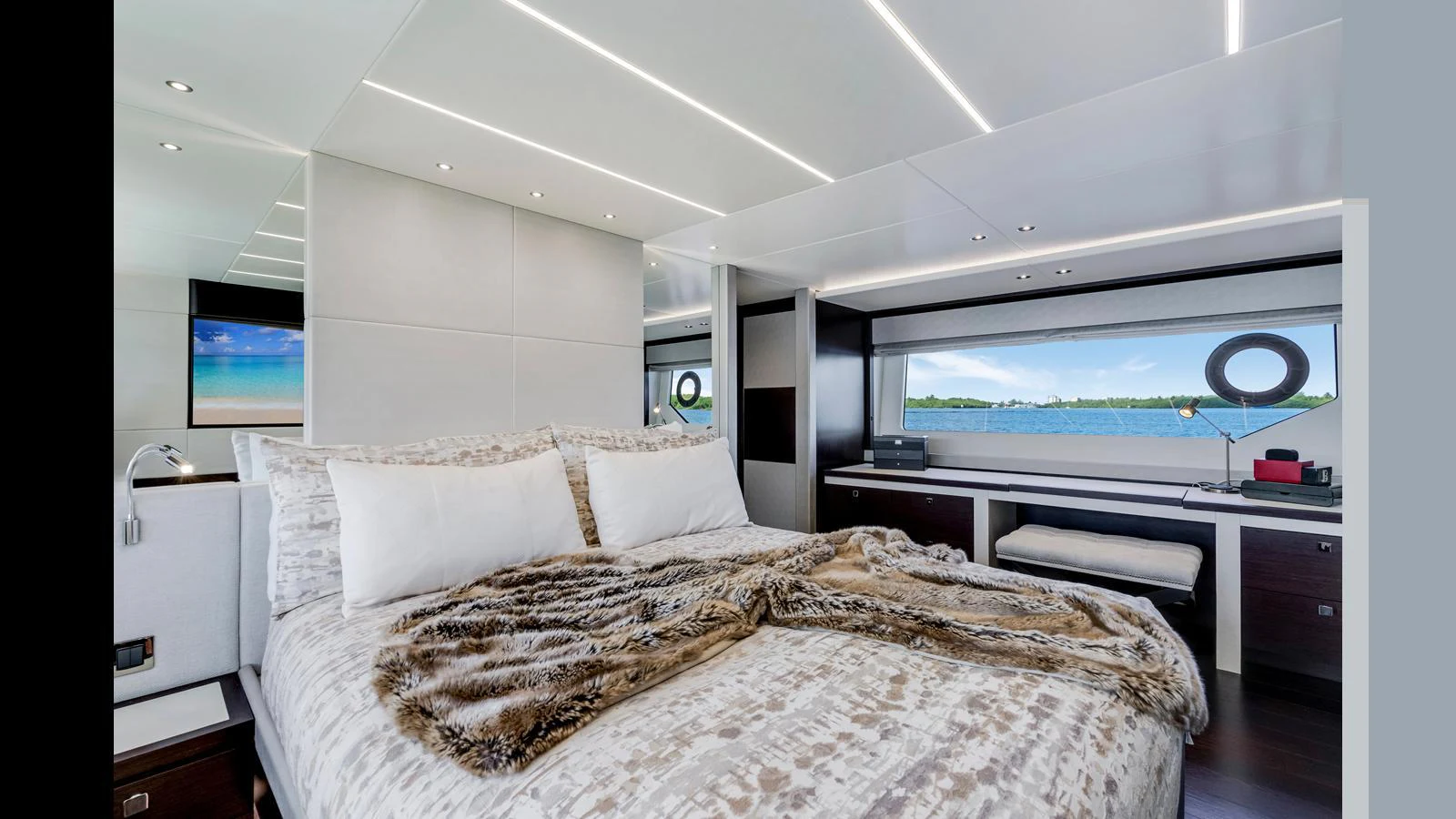 A luxurious stateroom with a large bed, modern decor, and expansive windows offering a stunning view of the water. aboard STEELN Yacht for Sale